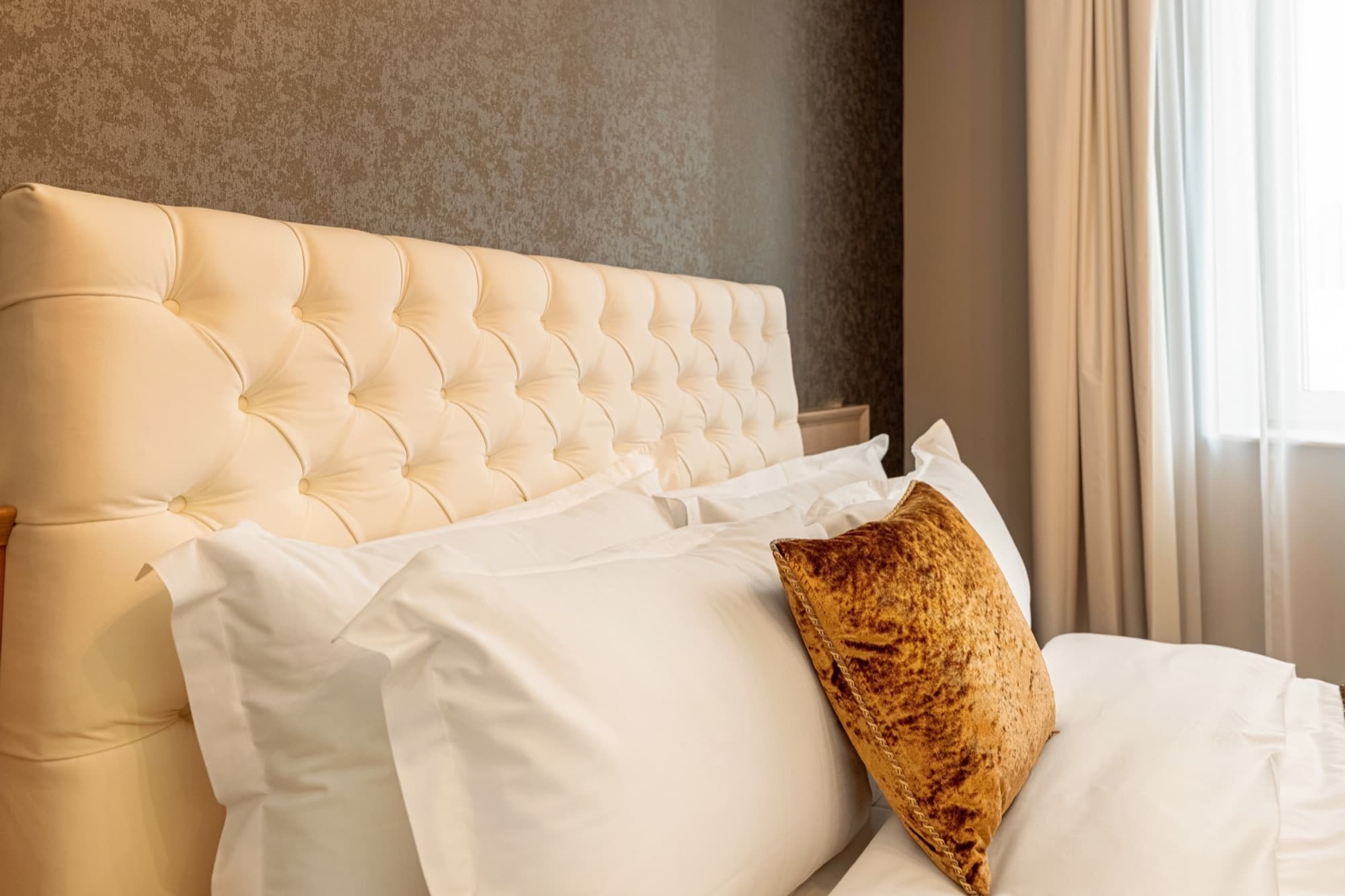 Guest room with upholstered headboard at Pergola Boutique Hotel Bucharest