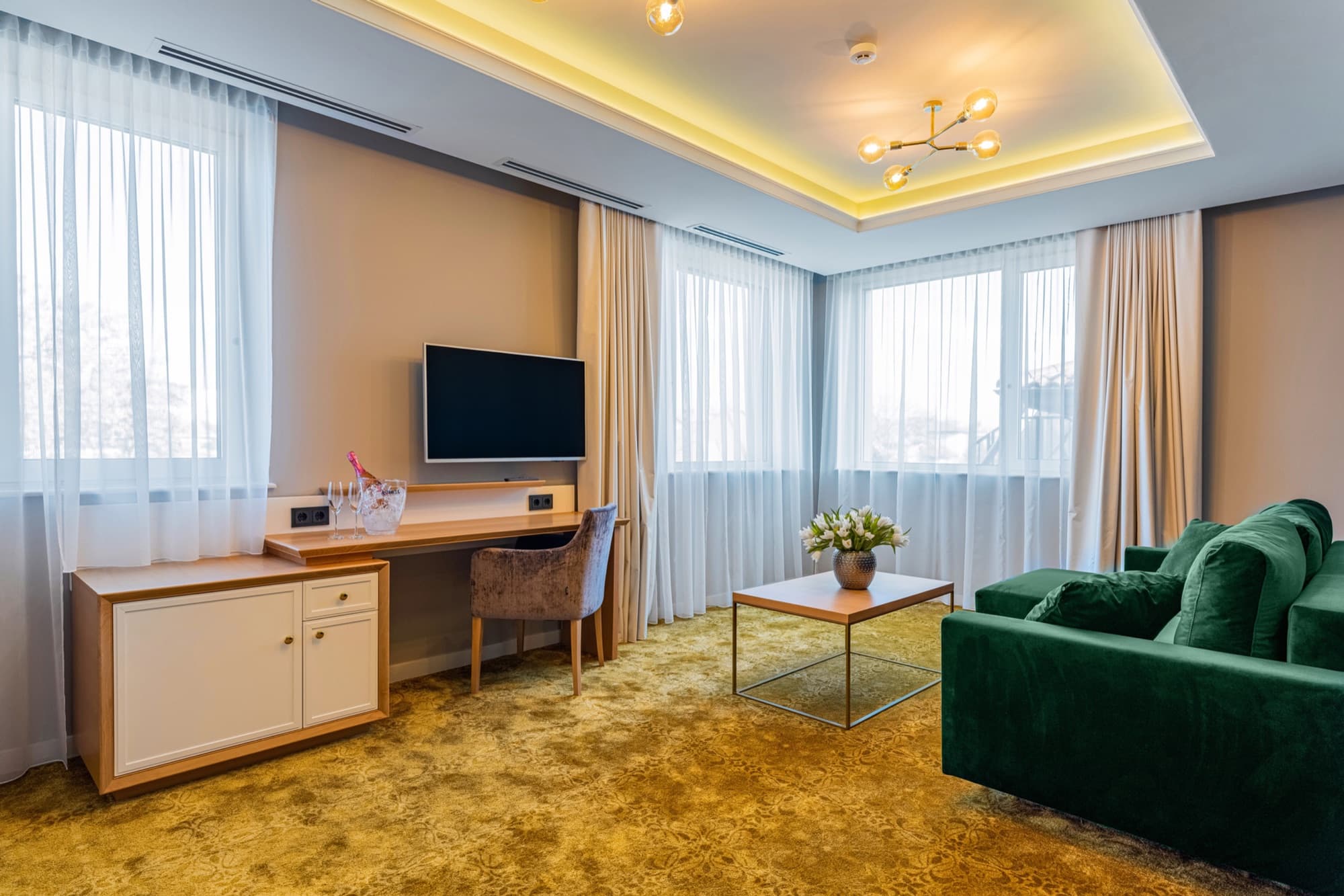 Guest room with lounge seating at Pergola Boutique Hotel Bucharest