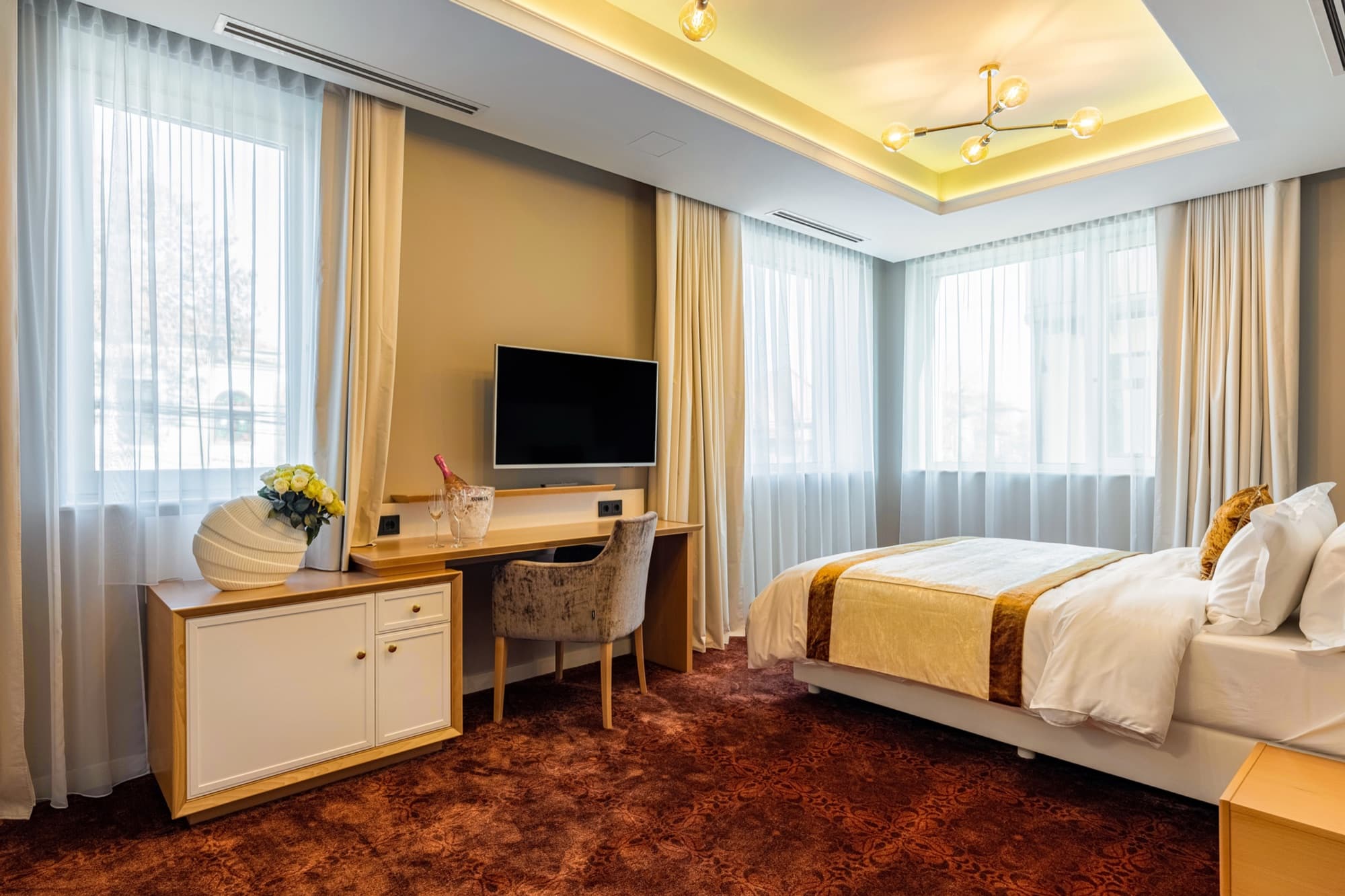 Guest room with seating area at Pergola Boutique Hotel Bucharest
